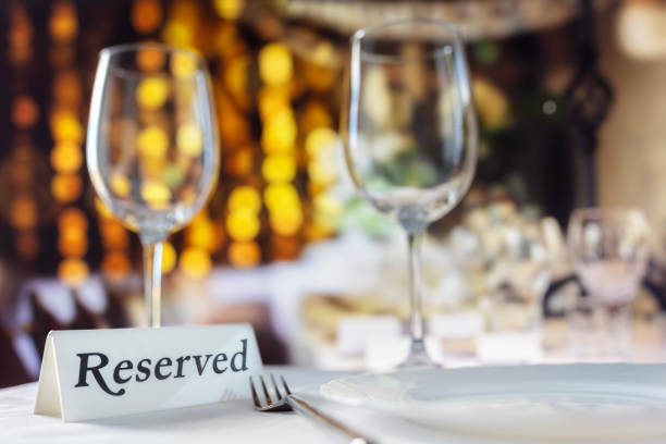 istock Restaurant reserved table sign with place setting and wine glasses ready for wedding party 2176103467