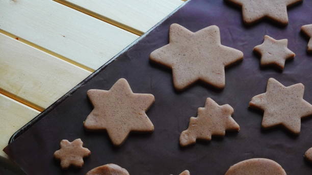 istock Raw Cinnamon Cookies Shaped Stars Trees Close-Up Brown 2176104188