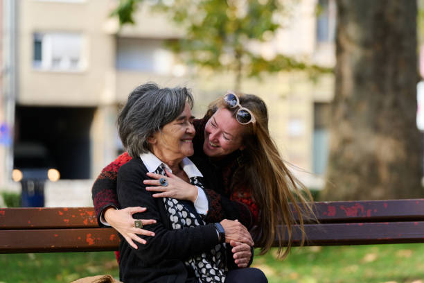 istock Embracing Generations: A Daughter's Love and Support for Her Senior Mother on a Sunny Day in the Park 2176107301
