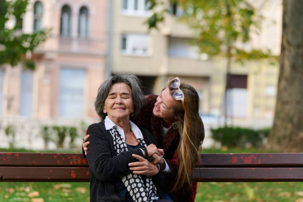 istock Embracing Generations: A Daughter's Love and Support for Her Senior Mother on a Sunny Day in the Park 2176107936