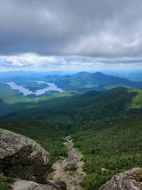 istock Mountain peak view over lush valley and distant mountains. 2176109466
