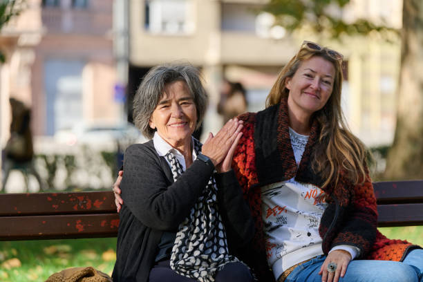 istock Embracing Generations: A Daughter's Love and Support for Her Senior Mother on a Sunny Day in the Park 2176110130