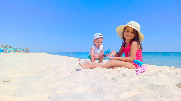 istock Happy children enjoying their vacation at the beach 2176111078