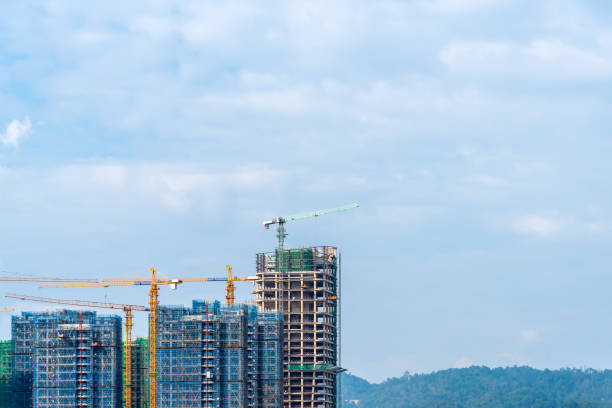 istock Construction crane of high rise building construction site with cloudy sky background. 2176112173
