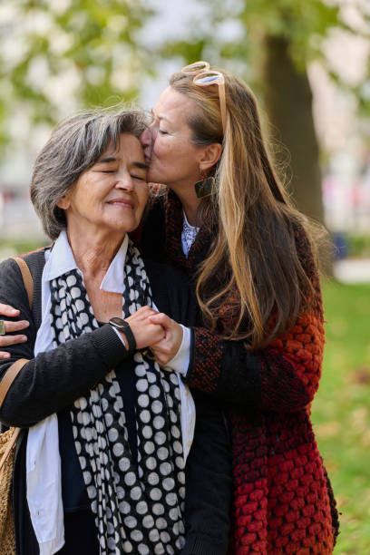 istock A Heartfelt Embrace: A Daughters Support for Her Mother on a Beautiful Autumn Day. 2176112594