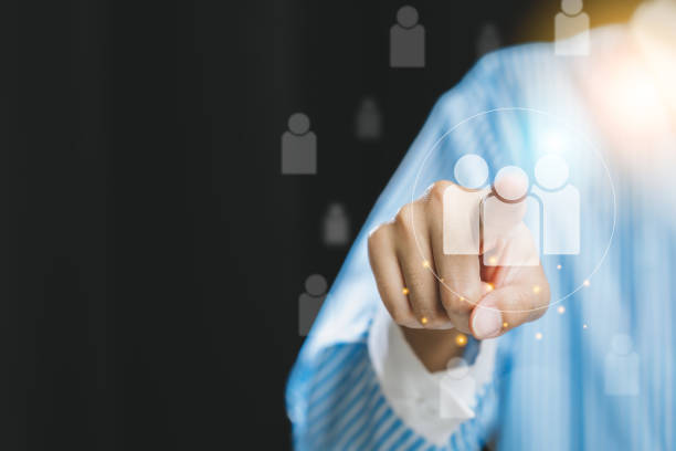 istock A person pointing towards digital user icons, symbolizing connection and engagement in a professional context. 2176114488
