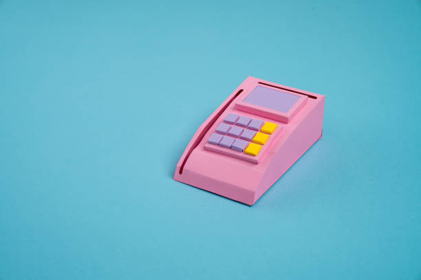 Toy wooden cash register on green background. Shopping concept.