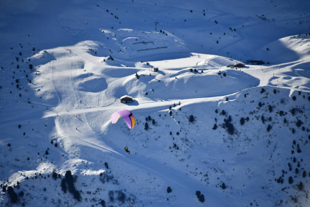 Winter scenery with a paraglider over the French mountains by winter