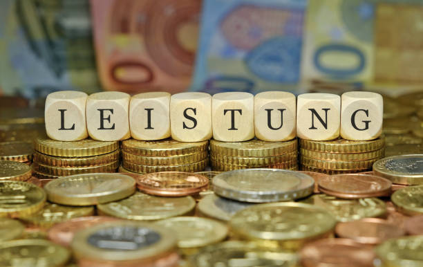 istock Performance, Output / financial and business concept. The word ‘LEISTUNG’ in German, on a stack of euro coins and banknotes. 2176117921