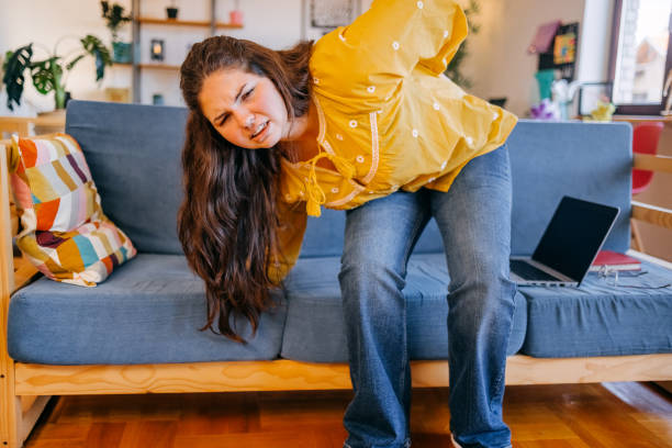 istock Young person feeling strong pain in the back at home 2176120189