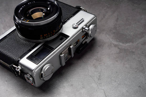 istock Old film camera isolated on dark background 2176124131