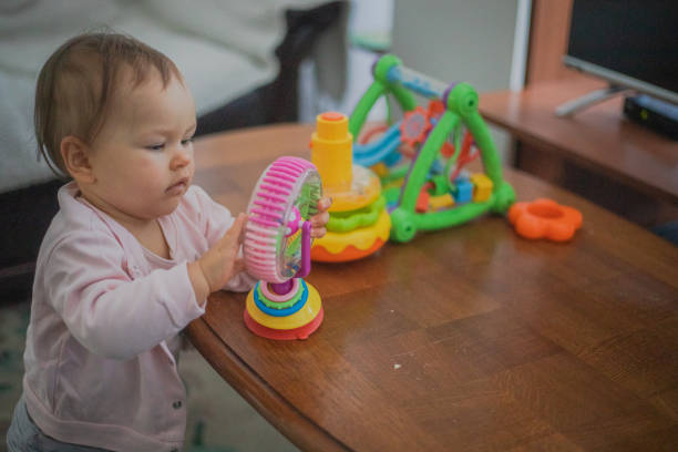 A small baby is playing with toys
