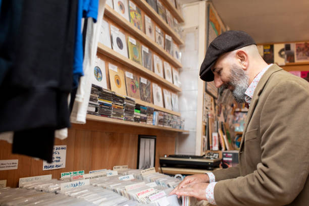 istock Man searching through vinyl in a record shop 2176128226