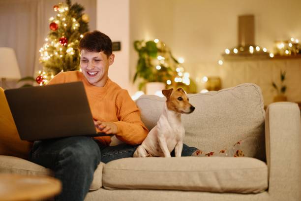 istock Smiling man relaxing at home with his dog 2176128360