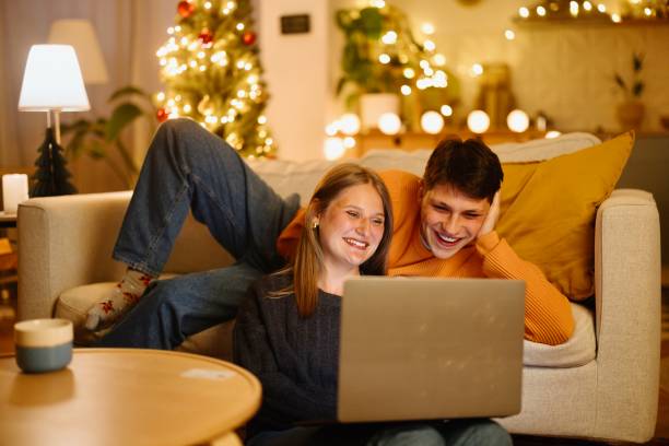 istock Boyfriend and girlfriend having a video call with someone 2176128367