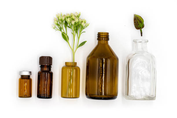 istock isolated on white background, colored glass bottles with essential oil and medicinal extracts, healthy lifestyle, body and health care, top view 2176128486