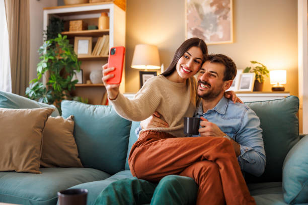 istock Couple taking selfies while relaxing at home 2176129319