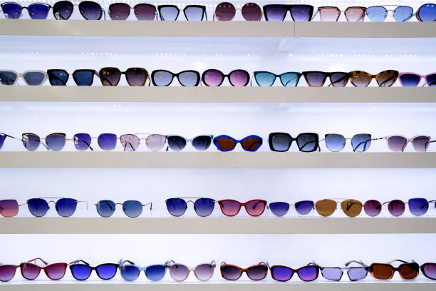 istock Organized rows of sunglasses, vibrant lenses in different styles, white shelves displaying fashion accessories, retail presentation enhancing shopping ambiance, front view 2176129373