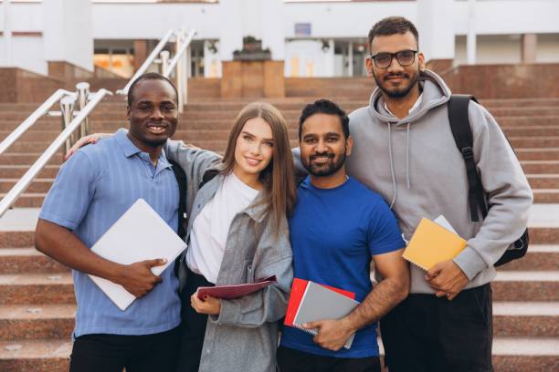 istock Diverse Group of Happy University Students Posing Together on Campus Steps Holding Notebooks 2176130417