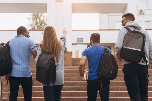 istock Group of Diverse College Students Walking Up Stairs on Campus With Backpacks 2176130629