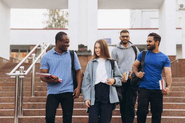istock Diverse Group of Students Walking on Campus Steps and Smiling With Books and Backpacks 2176130661