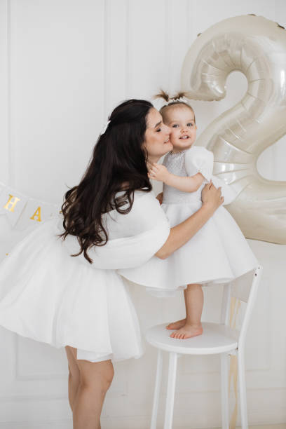 istock Mother celebrating daughter's second birthday with joy and love 2176133037