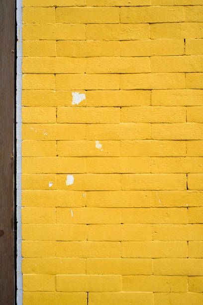 Yellow paint brick urban facade detail