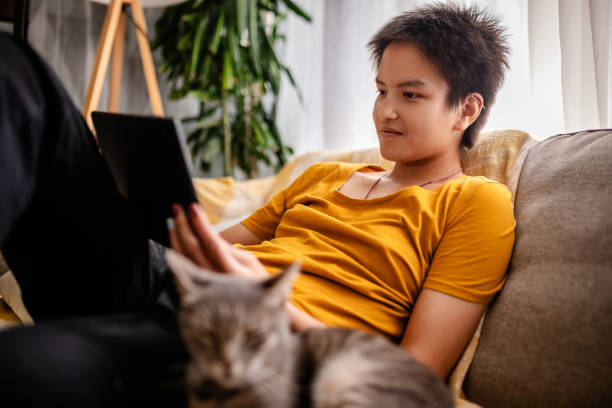 istock Relaxed individual with digital tablet by the cat 2176148086