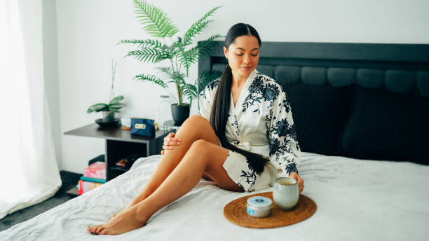 istock Woman at home using shea butter body cream 2176149411