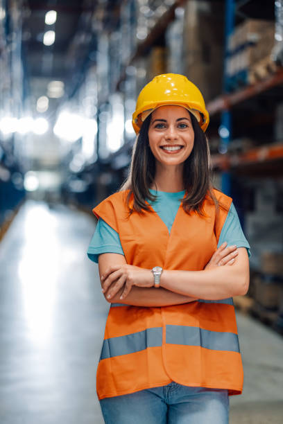 istock Central view of a smiling female warehouse worker in her gear 2176149603