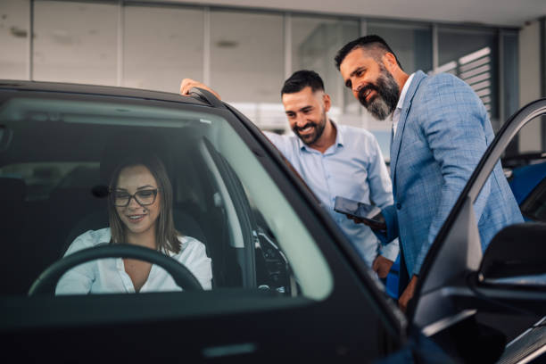 istock Car dealership provides attentive service to interested customer. 2176149657