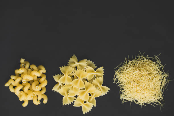 istock Three types of uncooked pasta on a dark background. 2176149800
