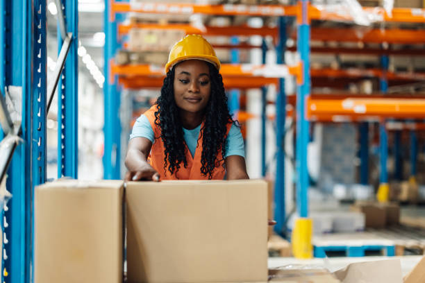 istock African american female worker organizing boxes in a busy warehouse. 2176149937