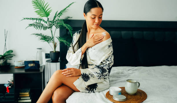 istock Woman at home using shea butter body cream 2176150118