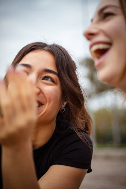 istock Two young women watch video on mobile phone screen. 2176150764