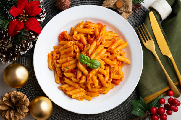 istock Macaroni with tomato and basil aroma. Top view table with Christmas decorations. 2176151223