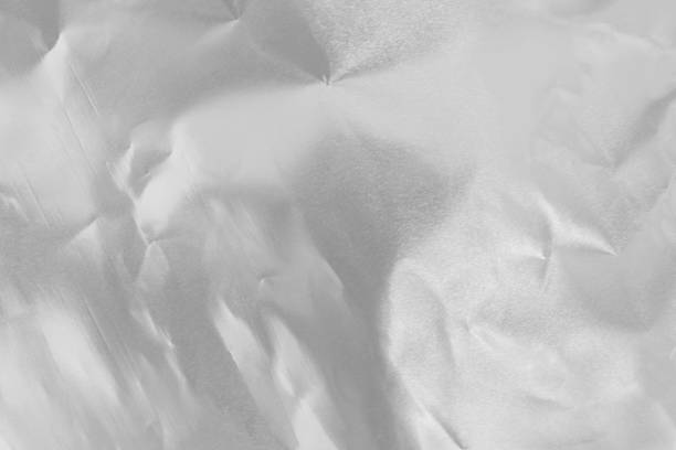 istock Shiny silver foil texture background, pattern of wrapping paper with crumpled and wavy. 2176151753