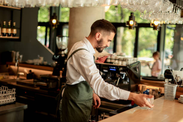 istock Talented bartender skillfully prepares a cocktail at a stylish urban bar on a sunny afternoon, showcasing artistry and precision in mixology 2176152023