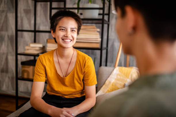 istock Smiling person in vibrant yellow chatting on the sofa. 2176153413