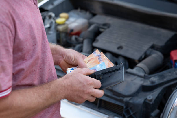 istock Service worker counting earned money and putting them to his wallet 2176153682