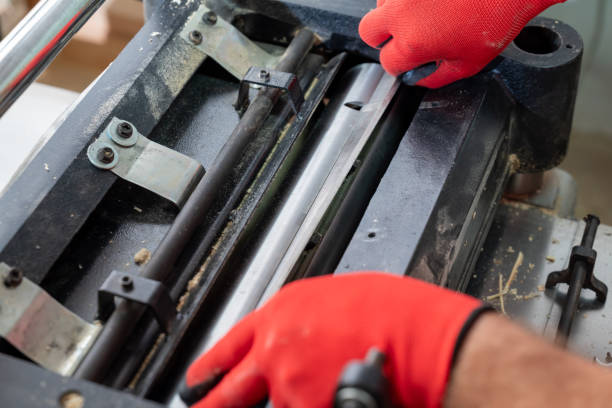 istock Professional carpenter changing knives in his wood cutting machine 2176153702