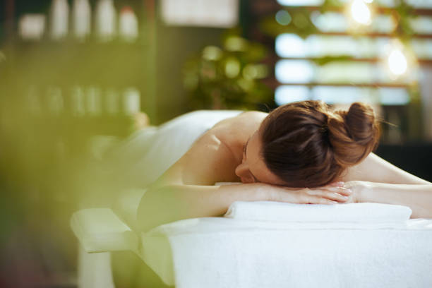 istock relaxed modern woman in spa salon laying on massage table 2176154250
