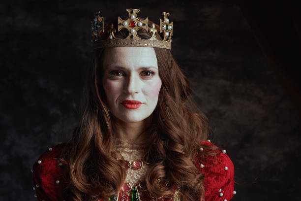 istock medieval queen in red dress with white makeup and crown 2176155366
