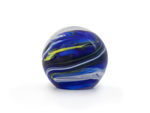 istock Large blue glass marble with yellow and white swirls. 2176159403