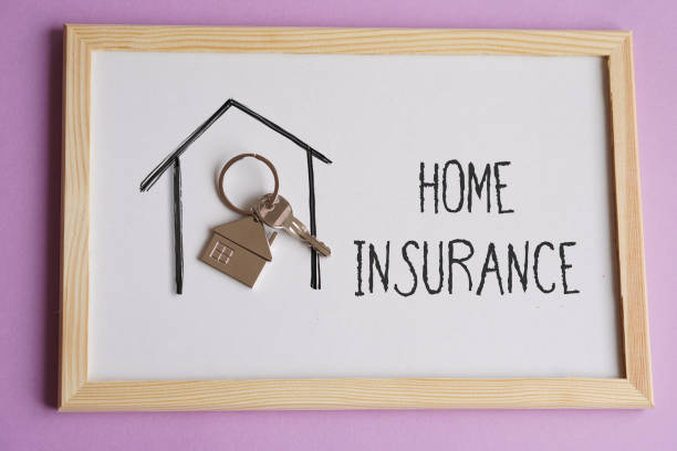 istock HOME INSURANCE. words written next to a house key. 2176160696