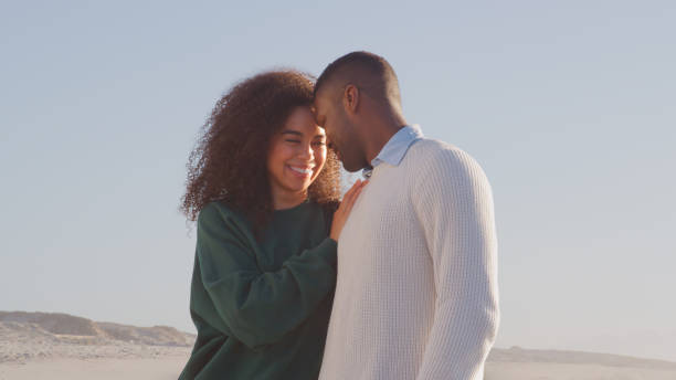 istock Casually Dressed Romantic Couple Walking Along Beach On Winter Vacation 2176171061