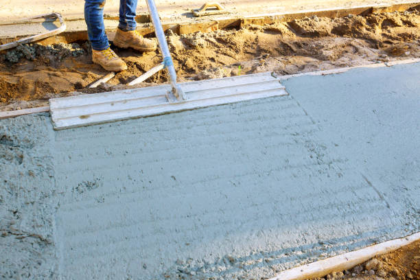istock Leveling concrete using a trowel during pouring of freshly concreted sidewalks 2176173374
