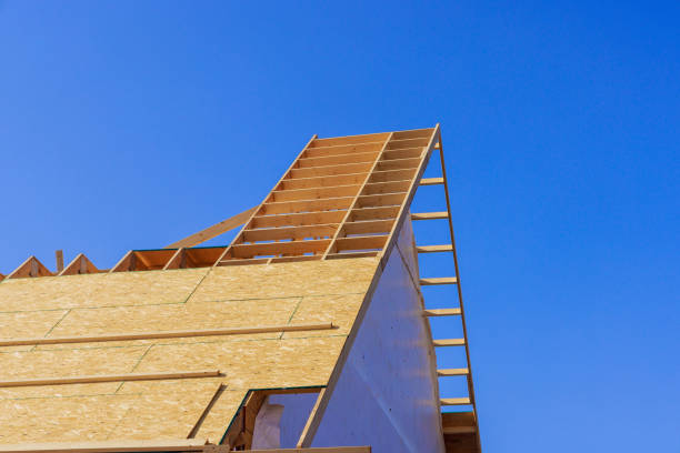 istock Installing wooden roofing trusses under construction roof on a house 2176174082