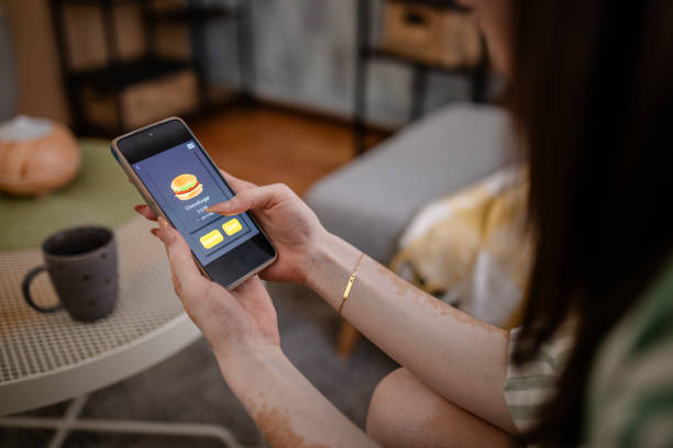 istock Woman ordering food using a smartphone app. 2176174118