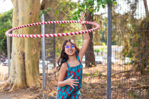 istock A child playing with a hula hoop. 2176176512